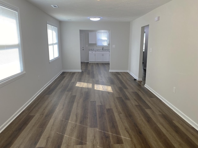 2113 Dyer St, Augusta, GA 30901 - unfurnished living room featuring a sink, dark wood-type flooring, and baseboards