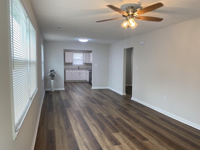 2113 Dyer St, Augusta, GA 30901 - unfurnished living room with a ceiling fan, dark wood-style floors, baseboards, and a sink