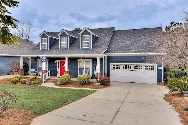 cape cod house featuring a shingled roof, concrete driveway, a porch, an attached garage, and a front lawn