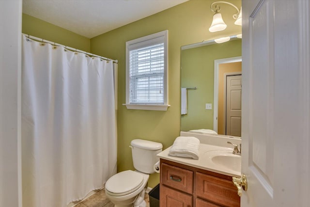 bathroom featuring toilet, tile patterned floors, and vanity