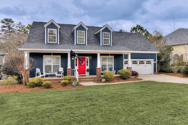 new england style home with an attached garage, covered porch, driveway, roof with shingles, and a front yard