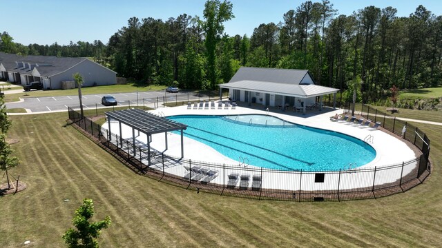 view of swimming pool with a lawn and a patio