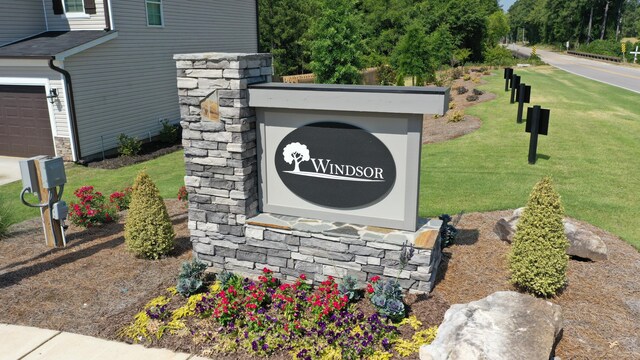 community / neighborhood sign with a lawn