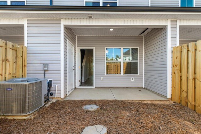 entrance to property with a patio and central AC unit