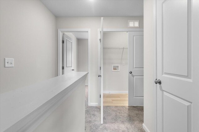 hallway featuring carpet flooring