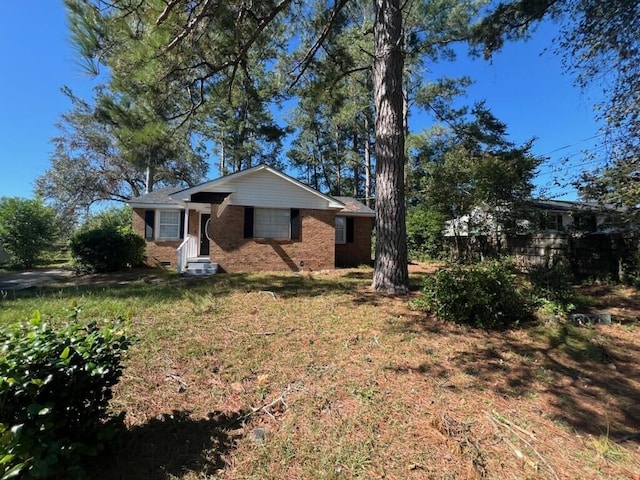 ranch-style home with a front lawn