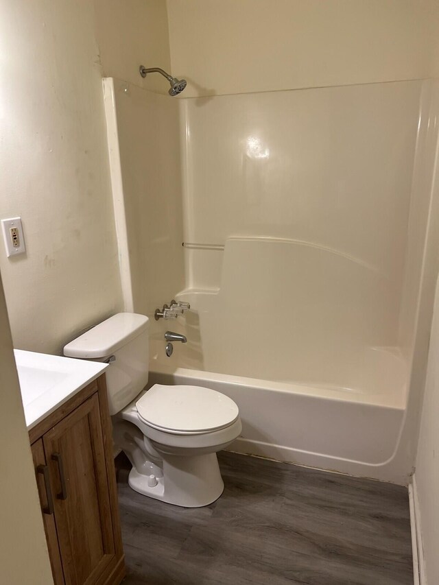 full bathroom featuring shower / washtub combination, hardwood / wood-style floors, vanity, and toilet