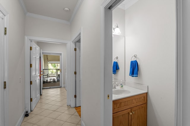 bathroom with crown molding, tile patterned floors, vanity, and baseboards