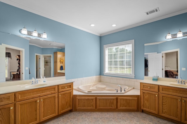 ensuite bathroom with a garden tub, a shower stall, two vanities, crown molding, and recessed lighting