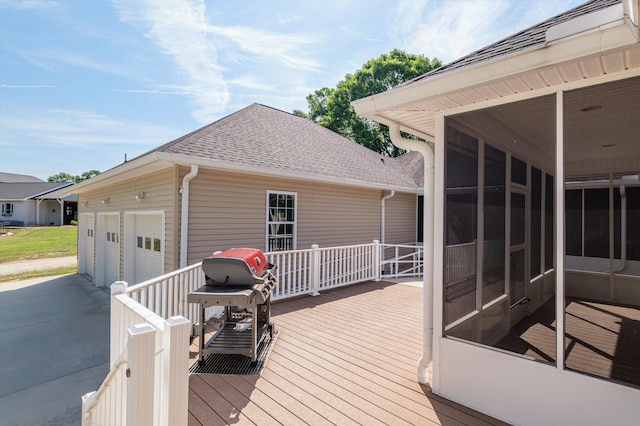wooden terrace with a sunroom and a garage