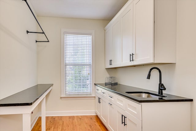 3954 Hammonds Fry, Evans, GA 30809 - kitchen with dark countertops, light wood finished floors, and white cabinets