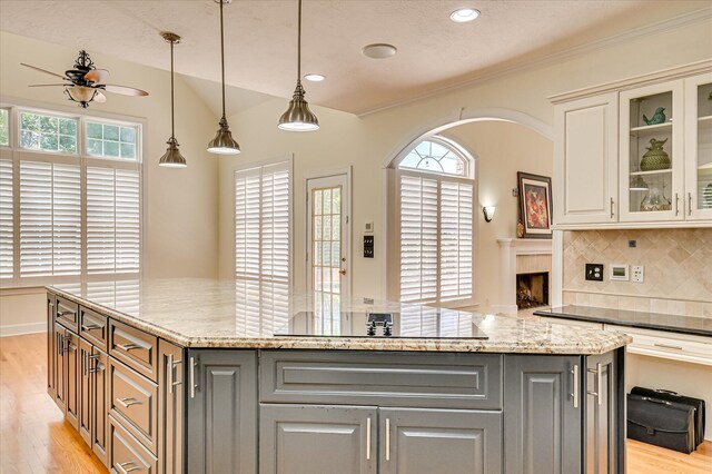 3954 Hammonds Fry, Evans, GA 30809 - kitchen featuring a ceiling fan, light wood-style flooring, gray cabinets, tasteful backsplash, and light stone counters