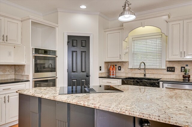 3954 Hammonds Fry, Evans, GA 30809 - kitchen with black electric stovetop, dark stone counters, backsplash, crown molding, and stainless steel double oven