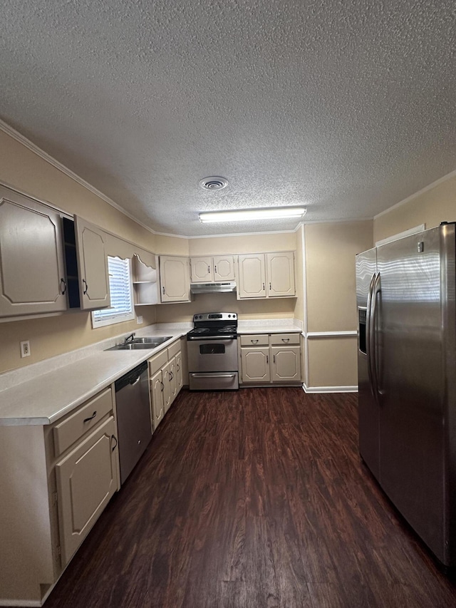 kitchen with sink, dark hardwood / wood-style floors, ornamental molding, a textured ceiling, and stainless steel appliances