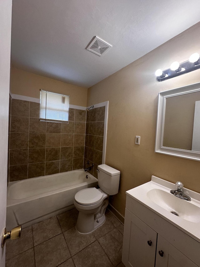 full bathroom with tile patterned flooring, vanity, toilet, and tiled shower / bath