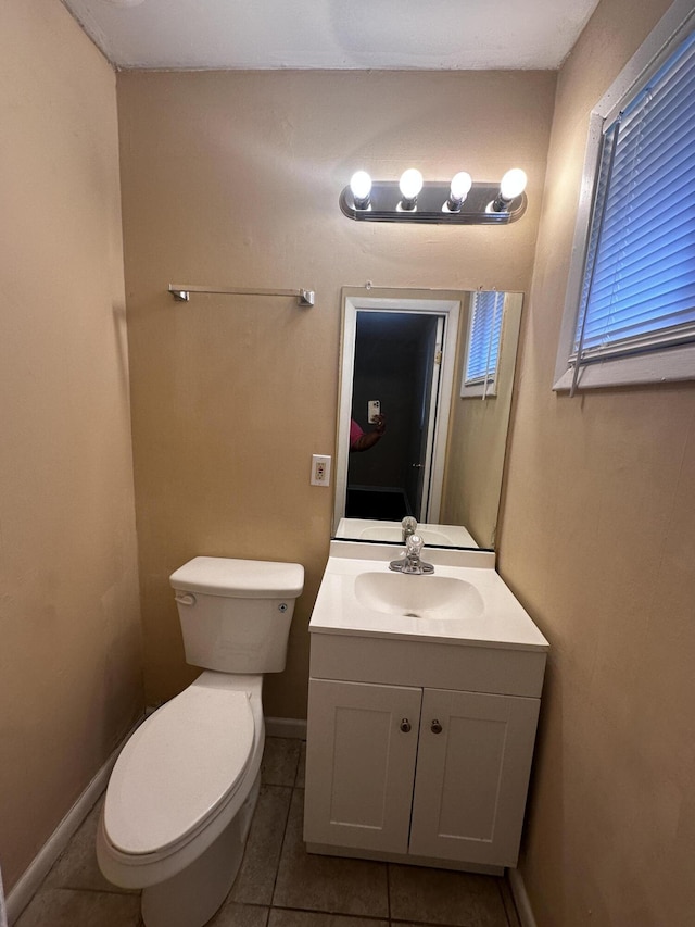 bathroom featuring tile patterned flooring, vanity, and toilet