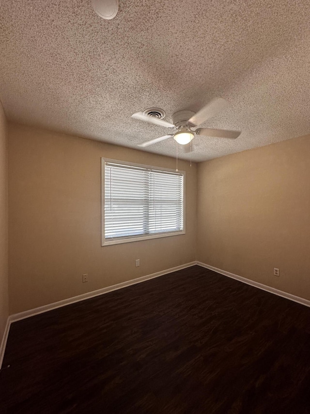 unfurnished room with a textured ceiling, ceiling fan, and dark hardwood / wood-style floors