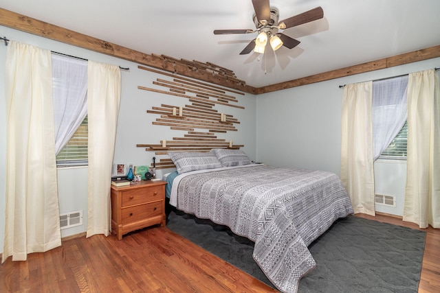 2211 Mura Dr, Augusta, GA 30906 - bedroom with wood finished floors, multiple windows, and ceiling fan