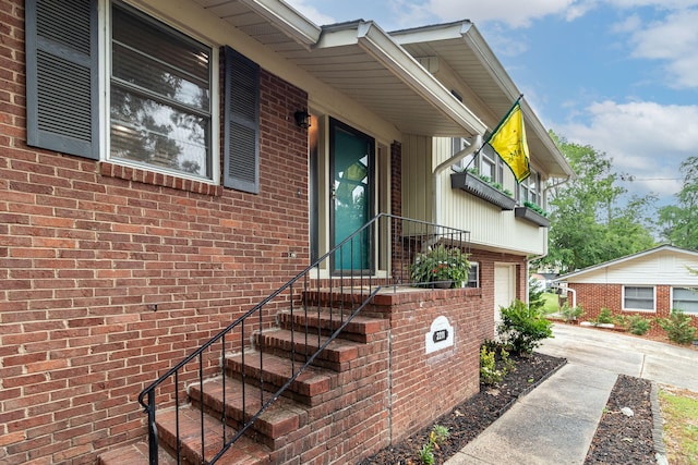 2211 Mura Dr, Augusta, GA 30906 - view of exterior entry featuring an attached garage, brick siding, and concrete driveway