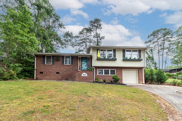 2211 Mura Dr, Augusta, GA 30906 - tri-level home with driveway, a garage, brick siding, and a front yard