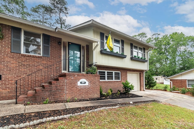 2211 Mura Dr, Augusta, GA 30906 - tri-level home featuring concrete driveway, a garage, and brick siding