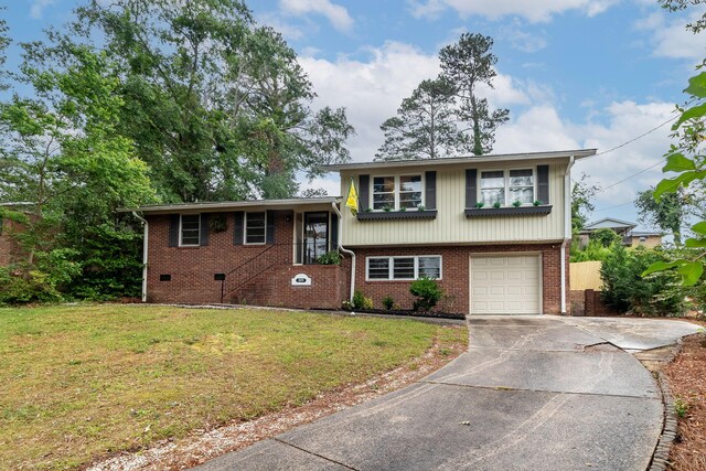 2211 Mura Dr, Augusta, GA 30906 - split level home featuring concrete driveway, a front lawn, brick siding, and an attached garage