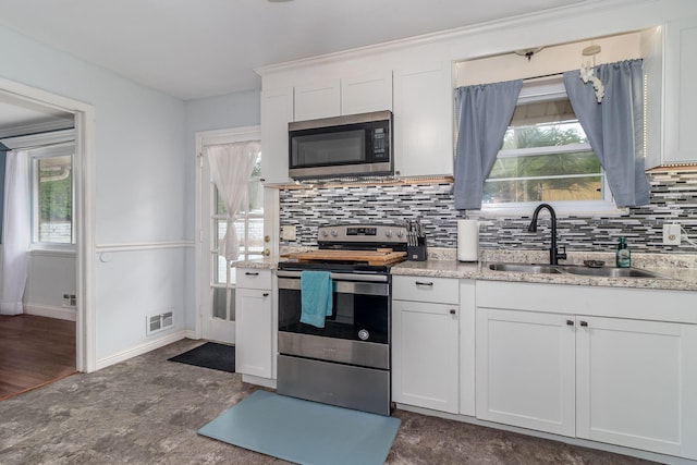 2211 Mura Dr, Augusta, GA 30906 - kitchen with appliances with stainless steel finishes, a sink, backsplash, and white cabinets