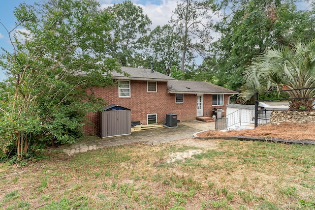 2211 Mura Dr, Augusta, GA 30906 - back of house with central AC unit, a patio, brick siding, fence, and a shed
