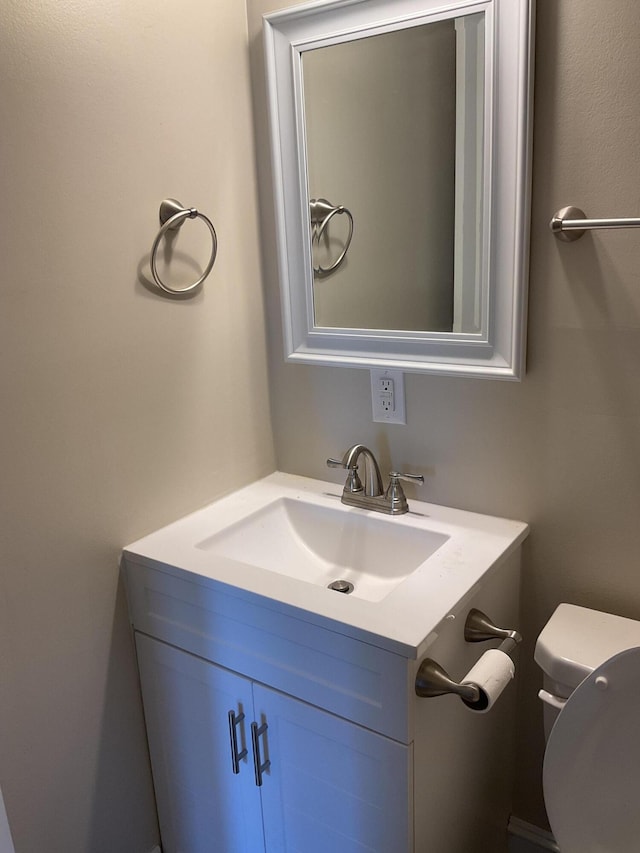 bathroom with toilet and vanity