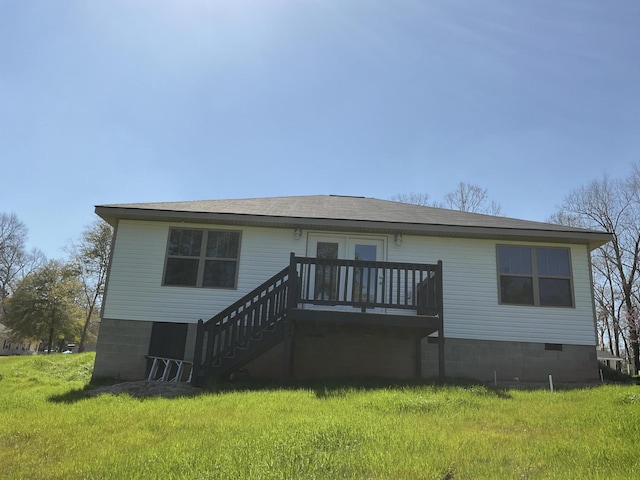 rear view of property featuring crawl space, stairway, and a yard