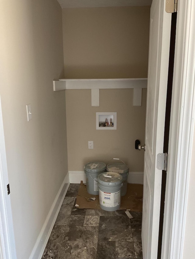 washroom with baseboards, washer hookup, and laundry area