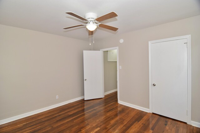 unfurnished bedroom with baseboards, wood finished floors, and ceiling fan