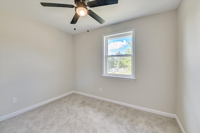spare room featuring carpet flooring, a ceiling fan, and baseboards