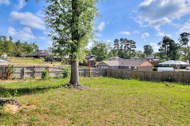 view of yard featuring fence and a residential view