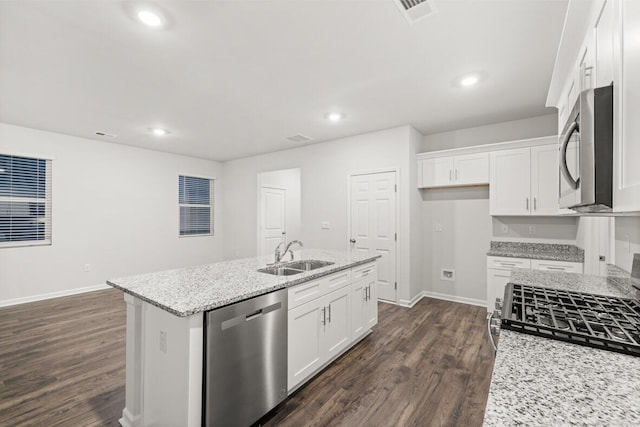 kitchen with sink, a center island with sink, white cabinets, and stainless steel appliances