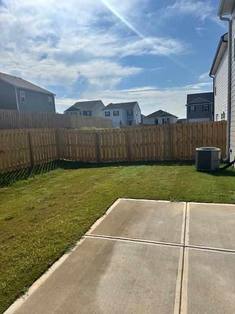 view of yard featuring central air condition unit and a patio