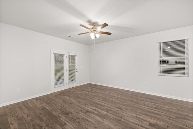 empty room with dark wood-type flooring and ceiling fan