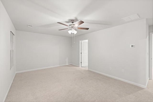 empty room featuring ceiling fan and light carpet