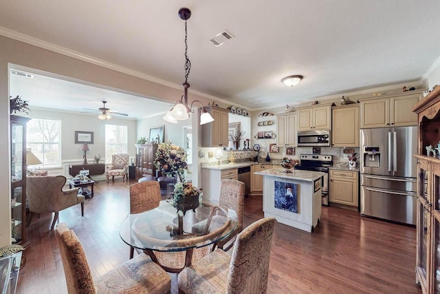 dining room featuring visible vents, dark wood finished floors, and crown molding