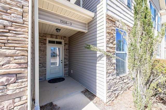 entrance to property with stone siding