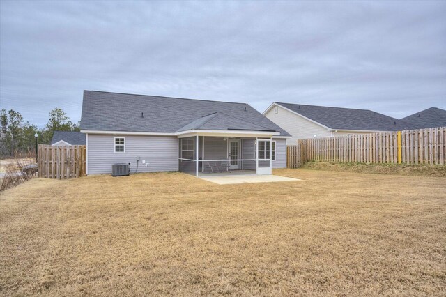 913 Goodale Dr, Augusta, GA 30909 - back of house featuring a sunroom, central AC unit, a yard, and a patio