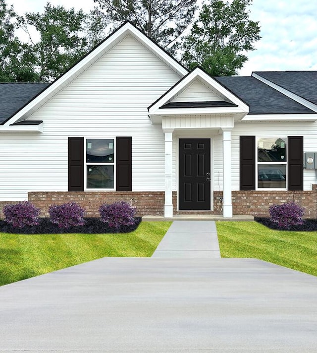 2243 Archer Ln, Augusta, GA 30906 - view of front facade featuring brick siding, roof with shingles, and a front lawn