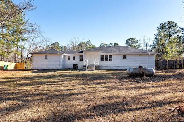 rear view of house featuring a lawn