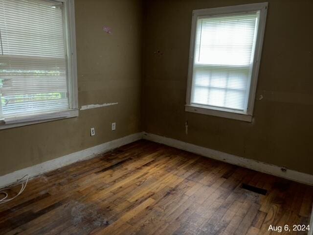 empty room featuring hardwood / wood-style floors and plenty of natural light