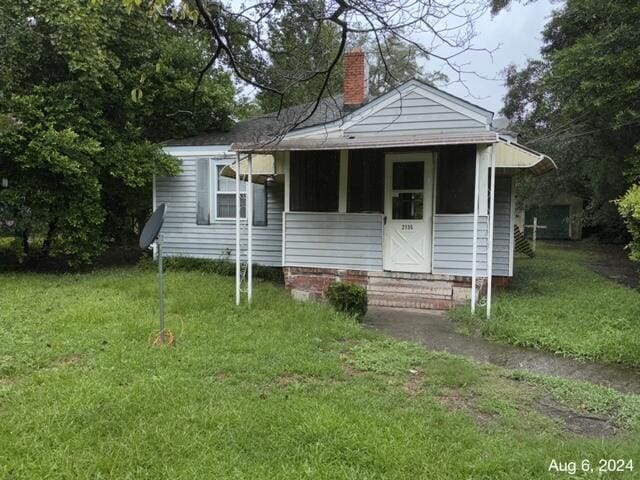 bungalow-style home featuring a front lawn