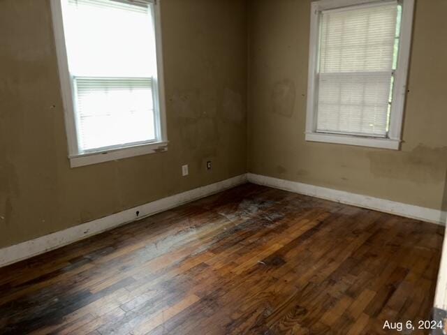 spare room featuring dark wood-type flooring