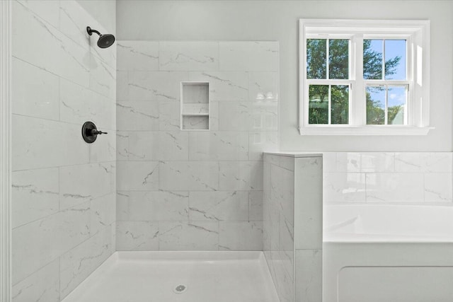 bathroom featuring separate shower and tub