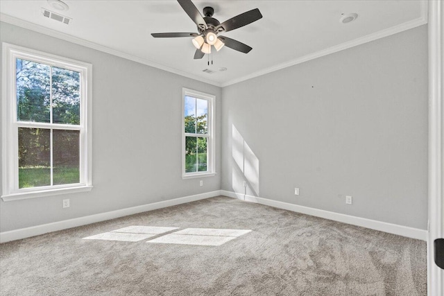 empty room featuring light carpet, ceiling fan, and crown molding