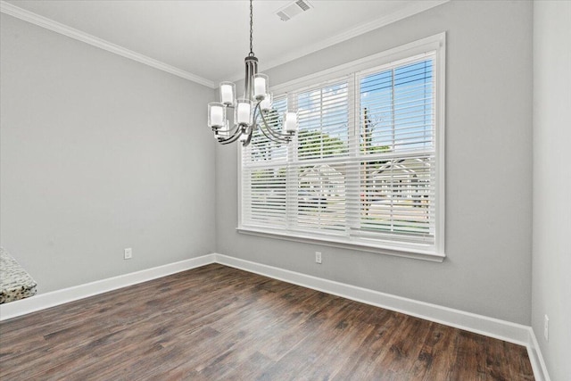 spare room with a chandelier, ornamental molding, and dark hardwood / wood-style flooring