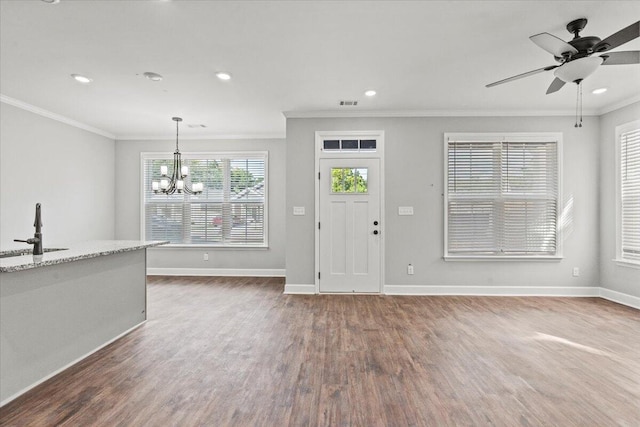 foyer featuring dark hardwood / wood-style flooring, crown molding, ceiling fan with notable chandelier, and sink